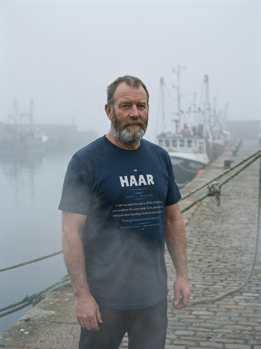Person on the coast wearing the navy HAAR dictionary definition tee