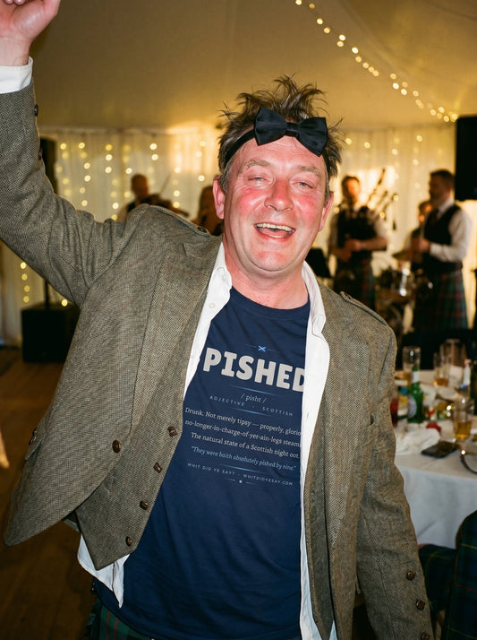 Person wearing the navy PISHED dictionary definition tee