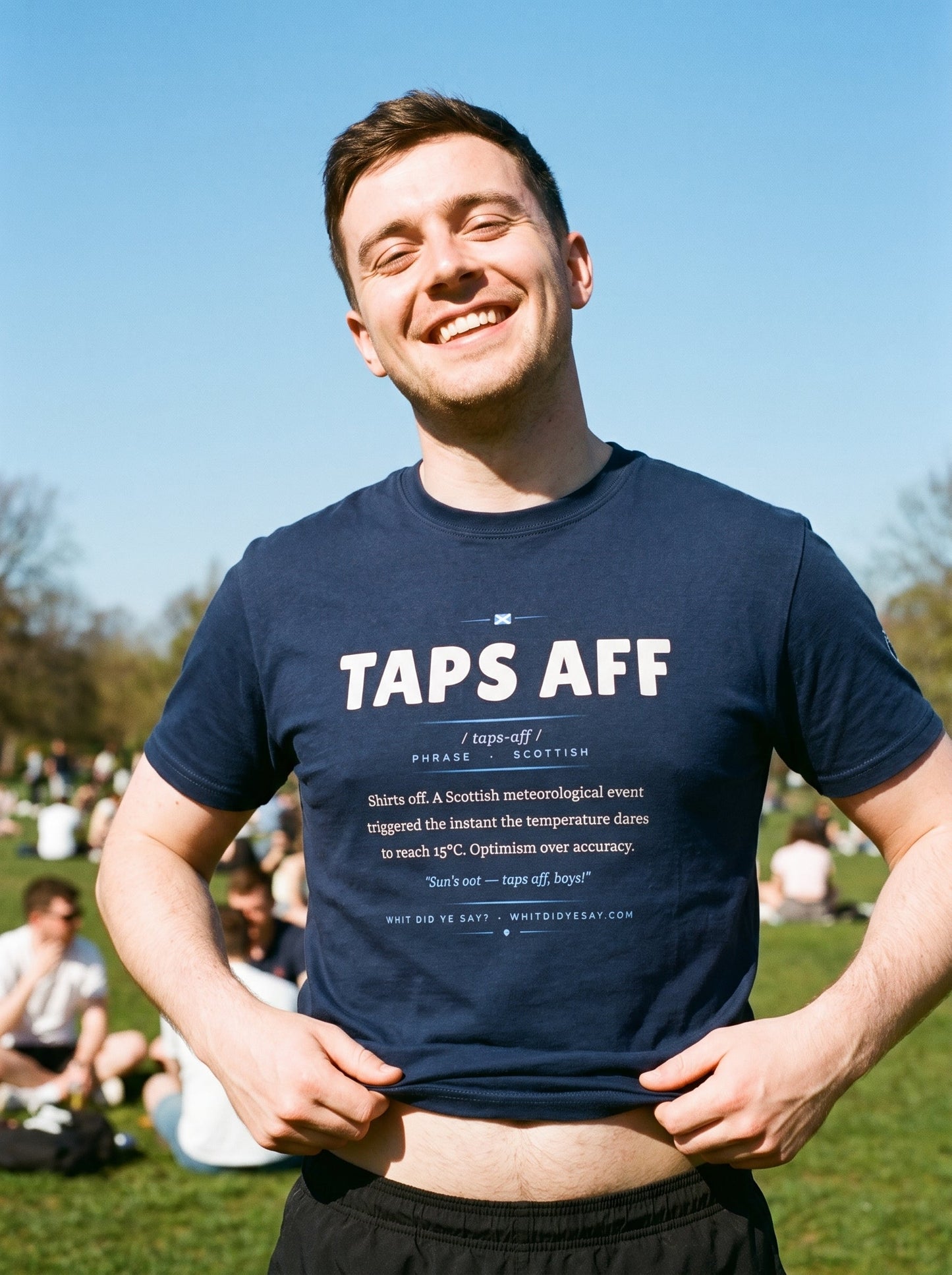 Person in the sunshine wearing the navy TAPS AFF dictionary definition tee